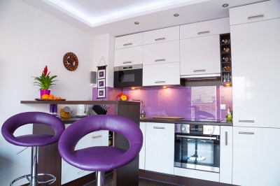 Modern living room interior with white and purple kitchen